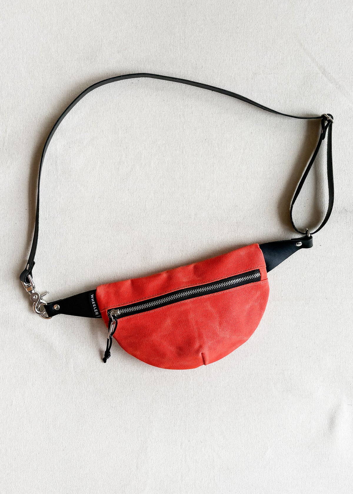 Handmade waxed canvas fanny pack in orange