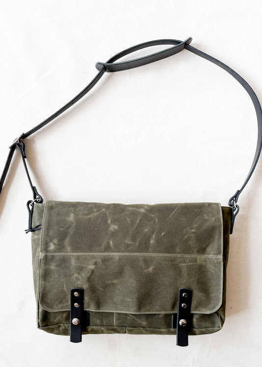 Olive waxed canvas messenger bag with black leather straps