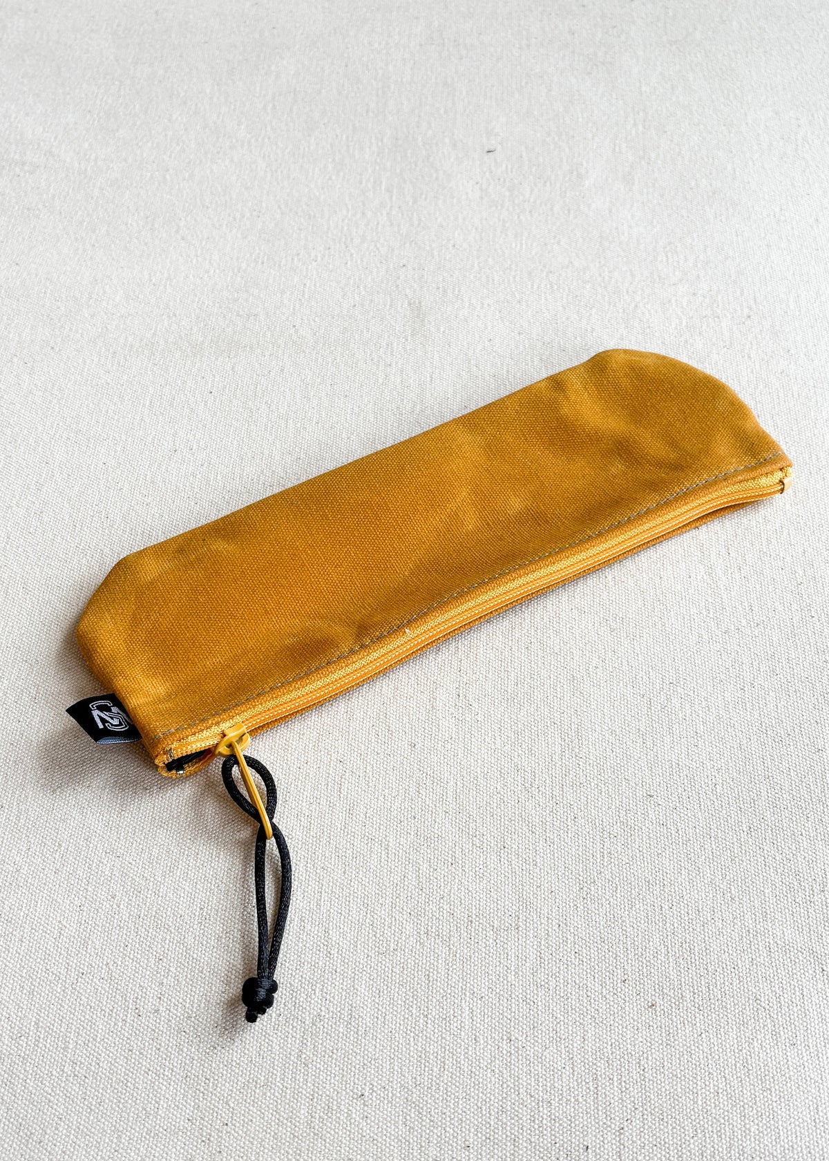Shift + Wheeler waxed canvas pencil pouch in gold with gold zipper