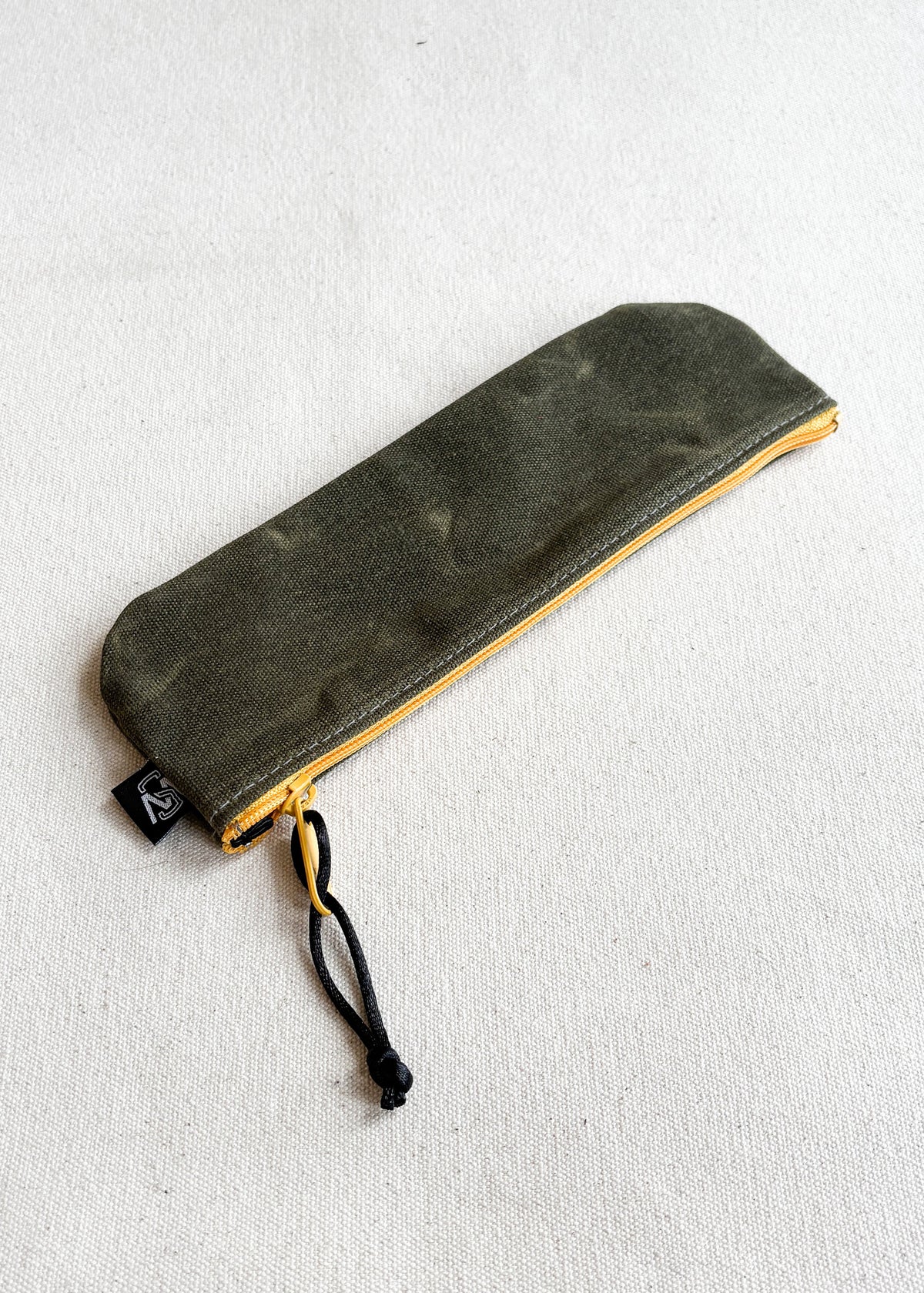 Shift + Wheeler waxed canvas pencil pouch in olive with yellow zipper