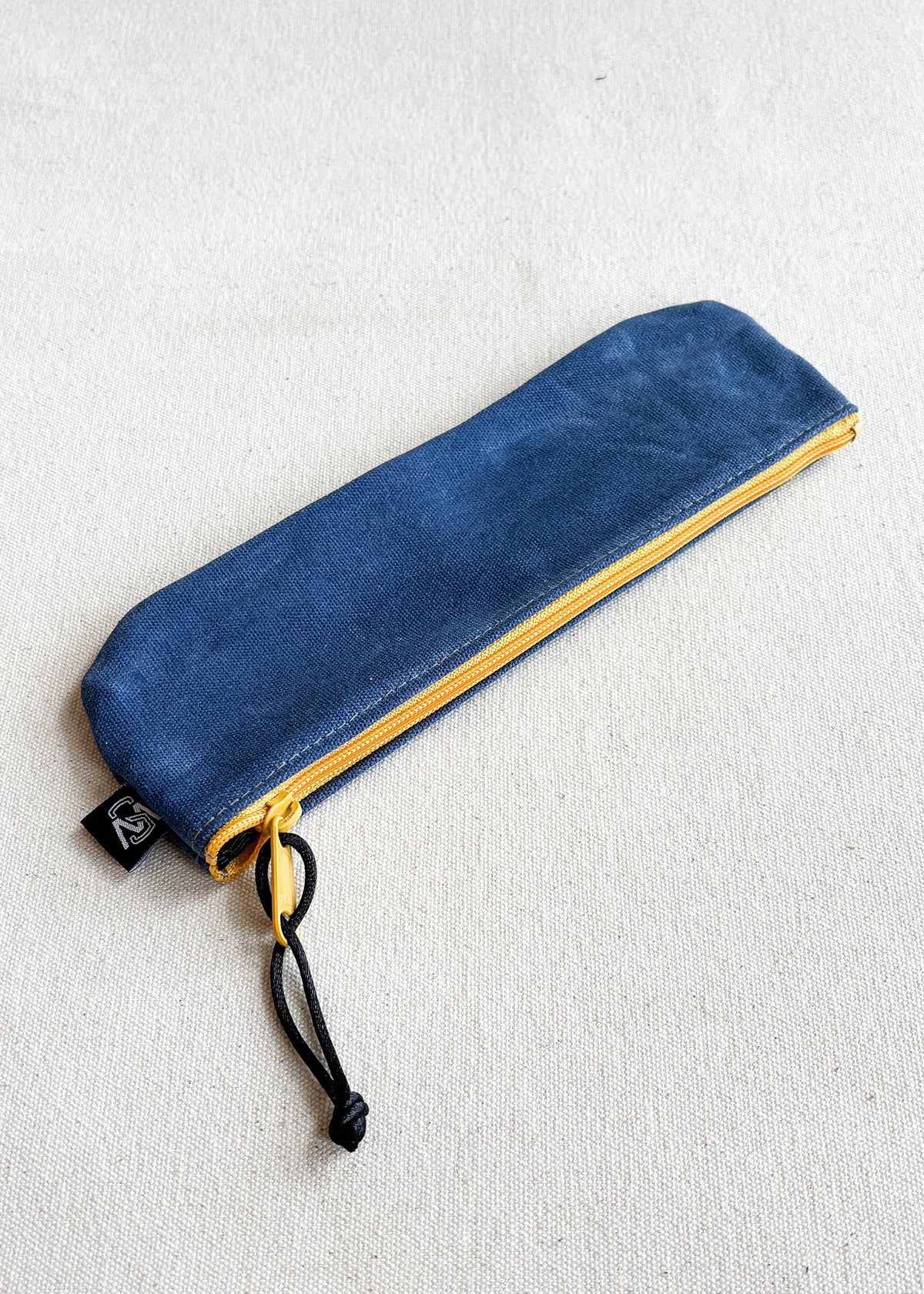 Shift + Wheeler waxed canvas pencil pouch in royal with yellow zipper