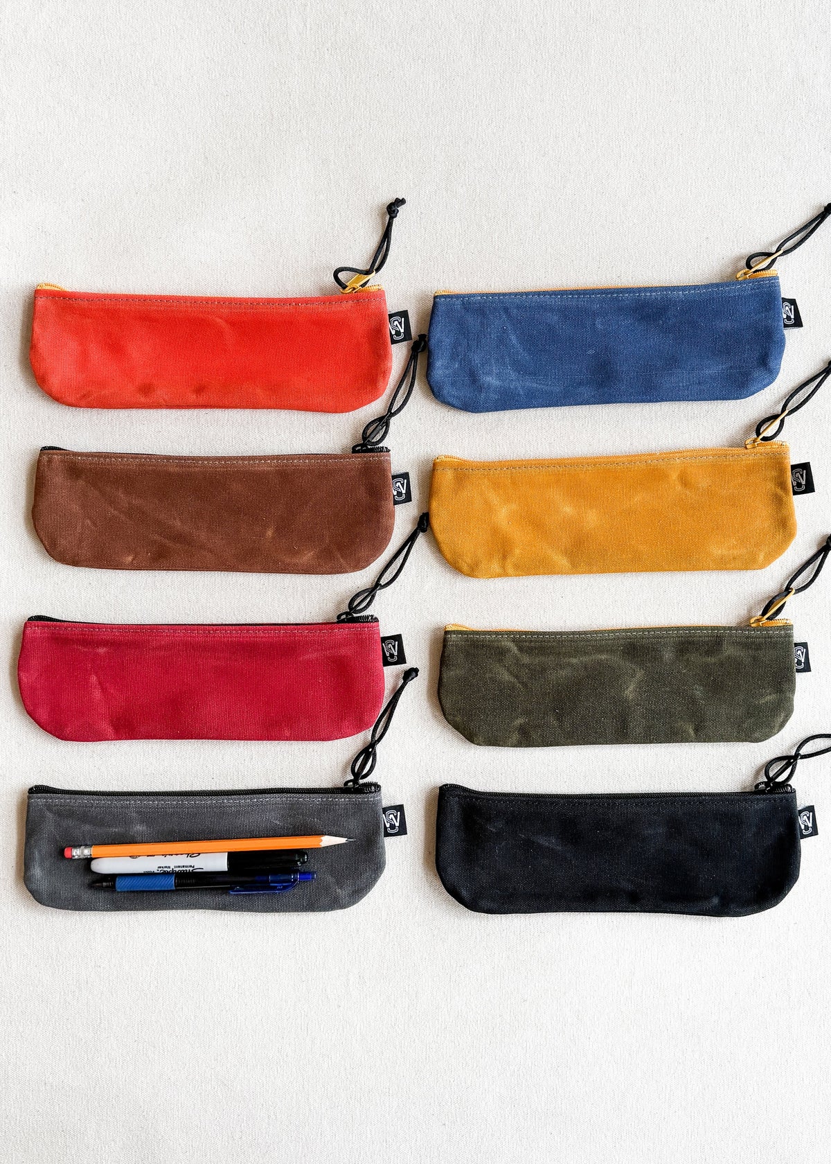 Assortment of Shift + Wheeler waxed canvas pencil pouches