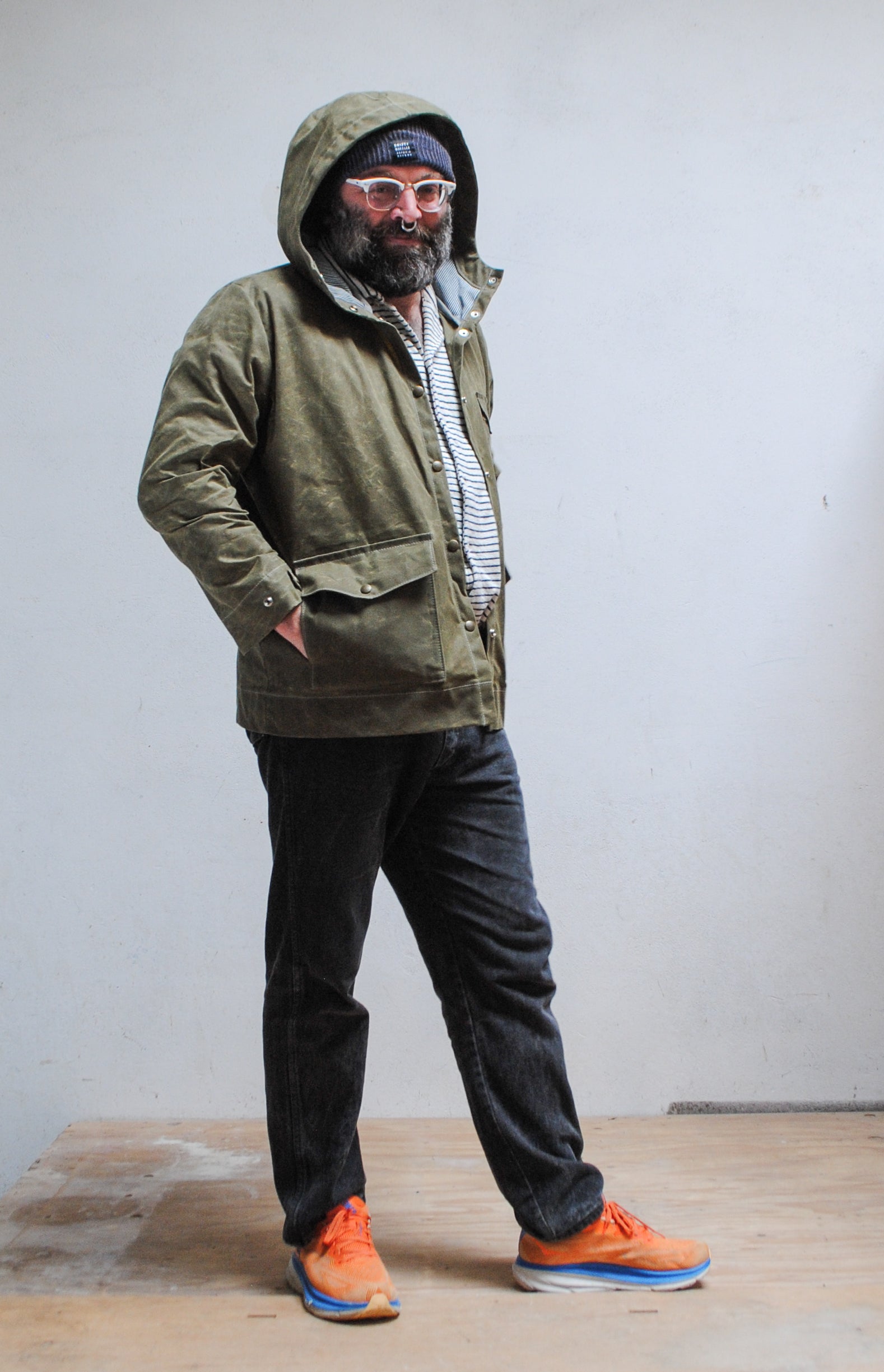 Side and top access pockets on handmade olive waxed canvas rain jacket