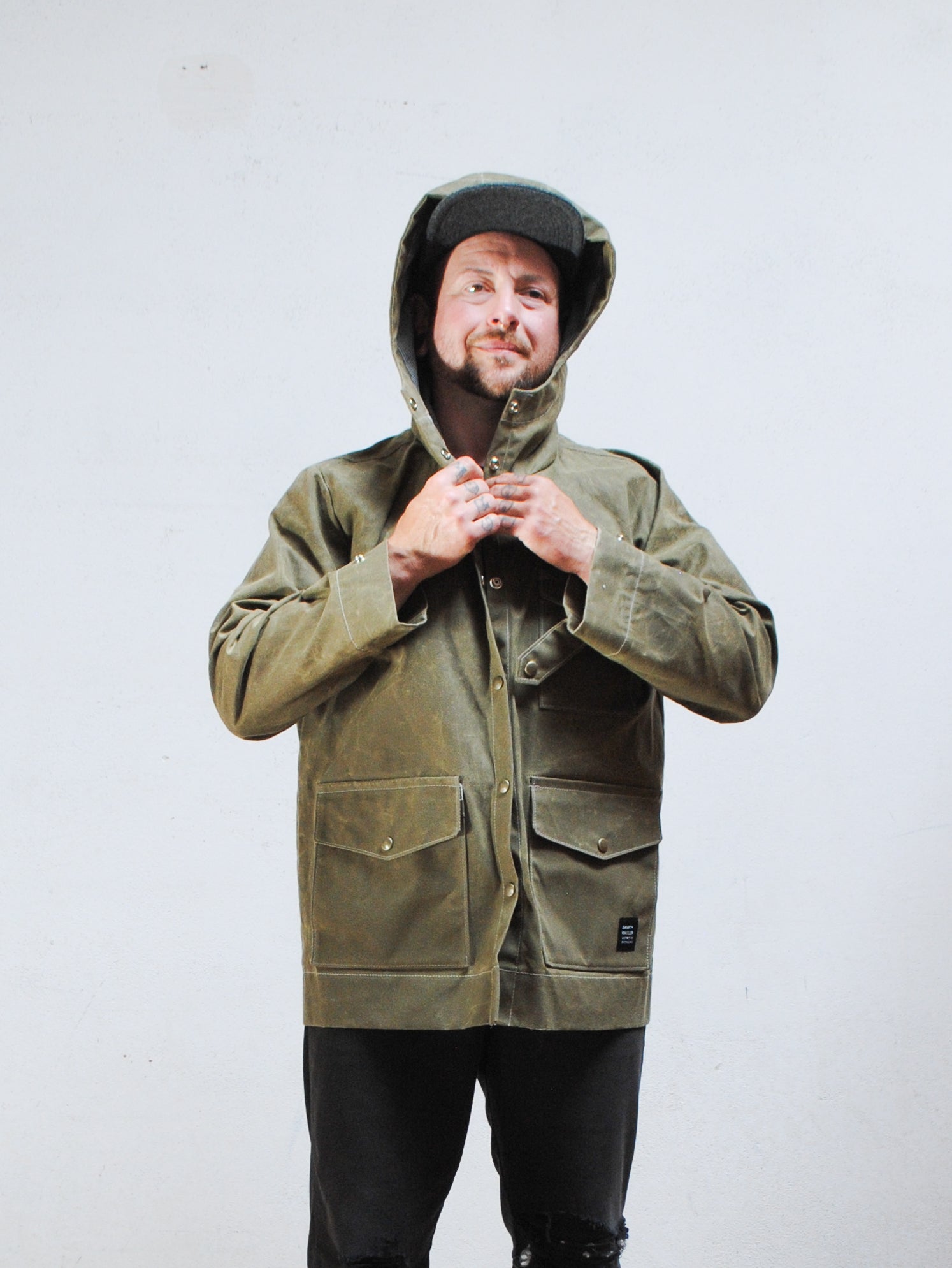 8oz waxed canvas detail with railroad denim accents on olive rain jacket
