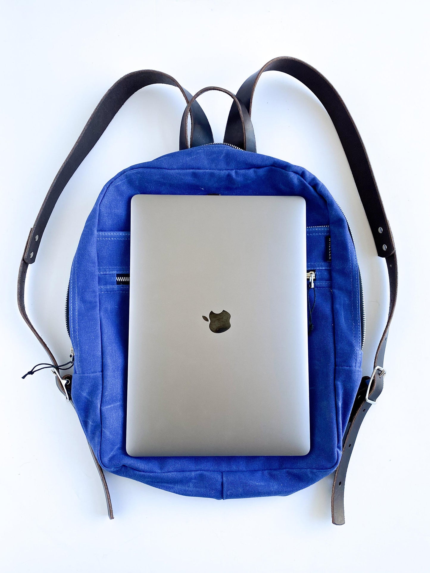 Waxed cotton canvas backpack with laptop, size example.