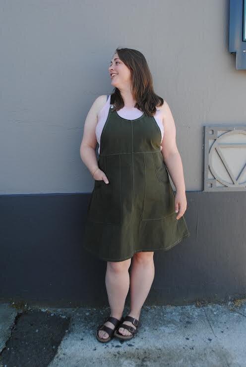 Evergreen suspender dress layered over tank top, styled by Shift + Wheeler