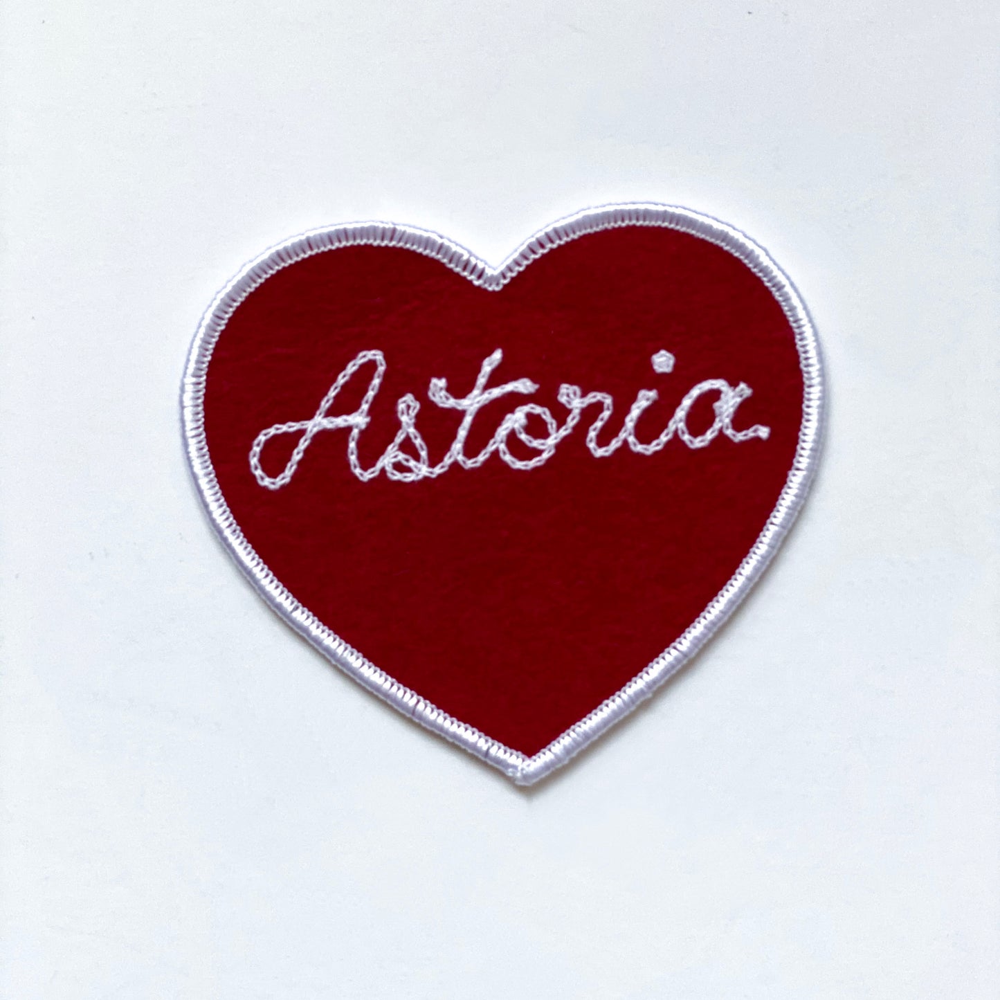Handmade, custom "Astoria" heart patch in red felt with white embroidery.