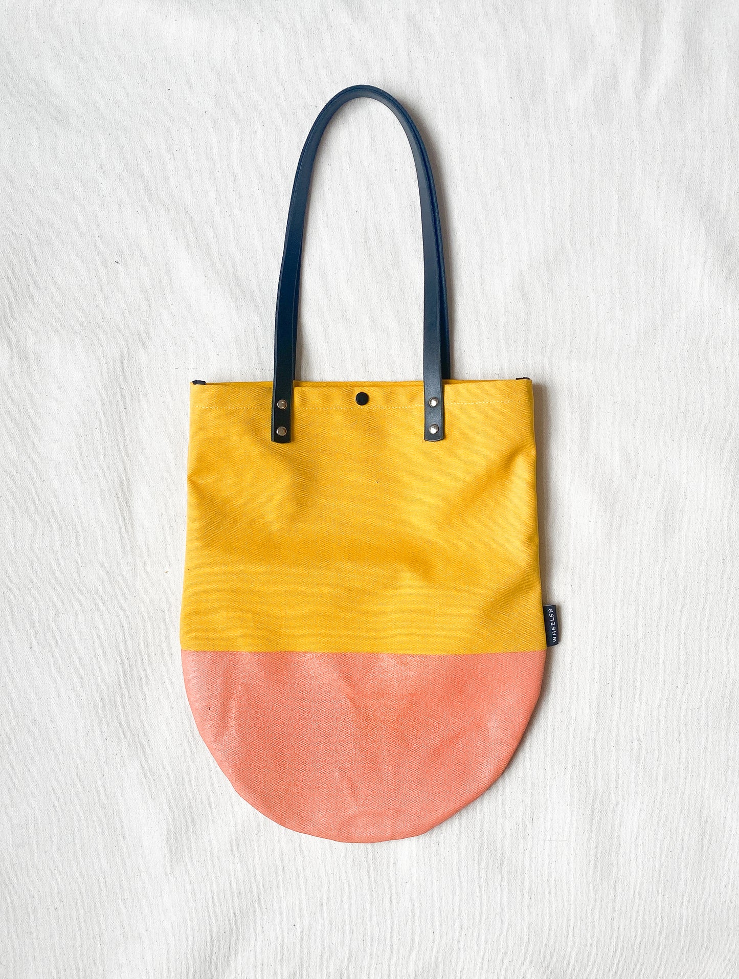 Round bottom tote in yellow. 