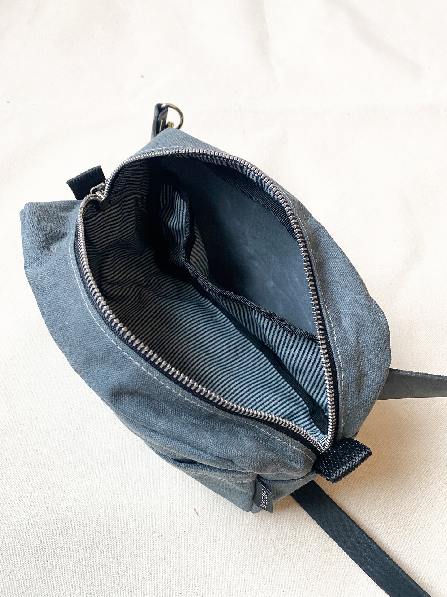 Interior view of Waxed Canvas cross body bag with leather strap. 