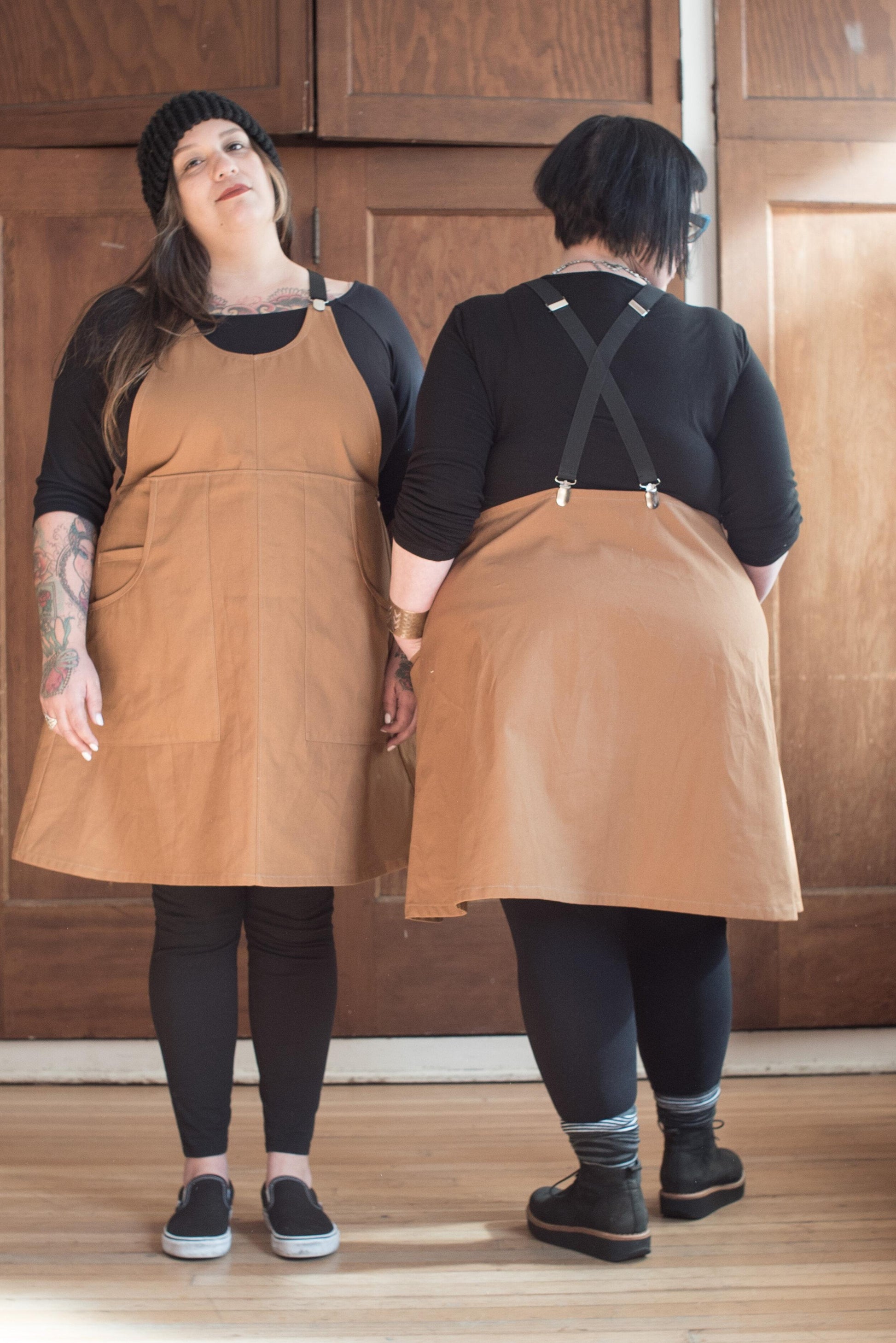 Front and back view of Caramel Canvas Suspender Dress on two models. 